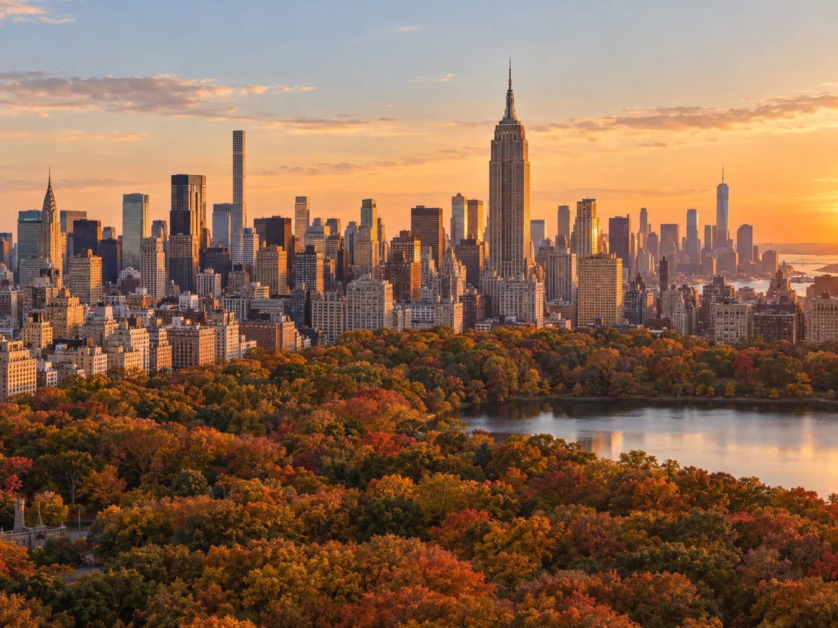 Manhattan skyline and the Empire State Building at golden hour above Central Park in autumn